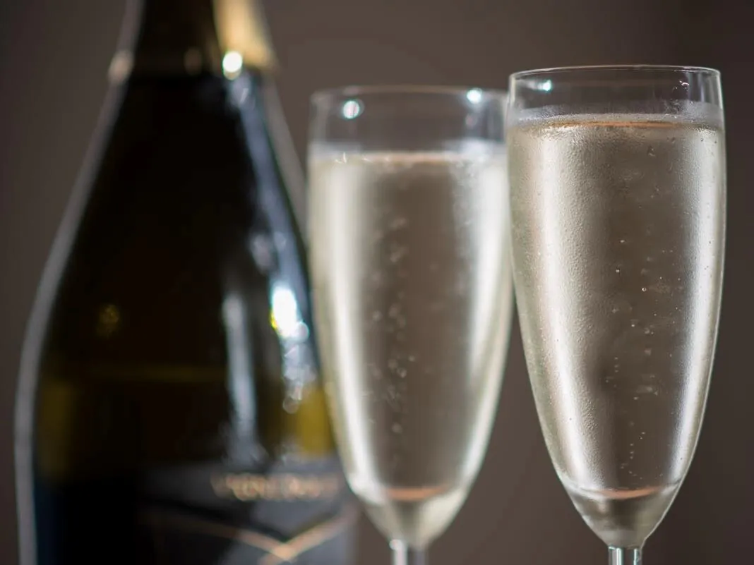 a bottle of champagne and two glasses with champage